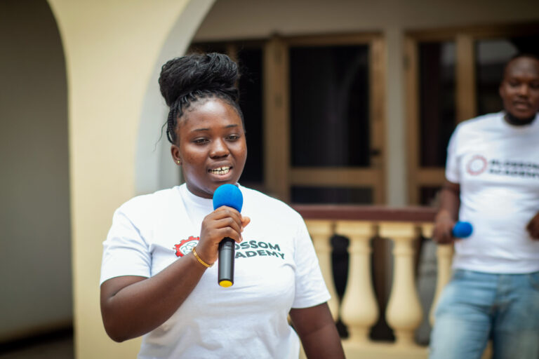 A woman holding a microphone in her hand.